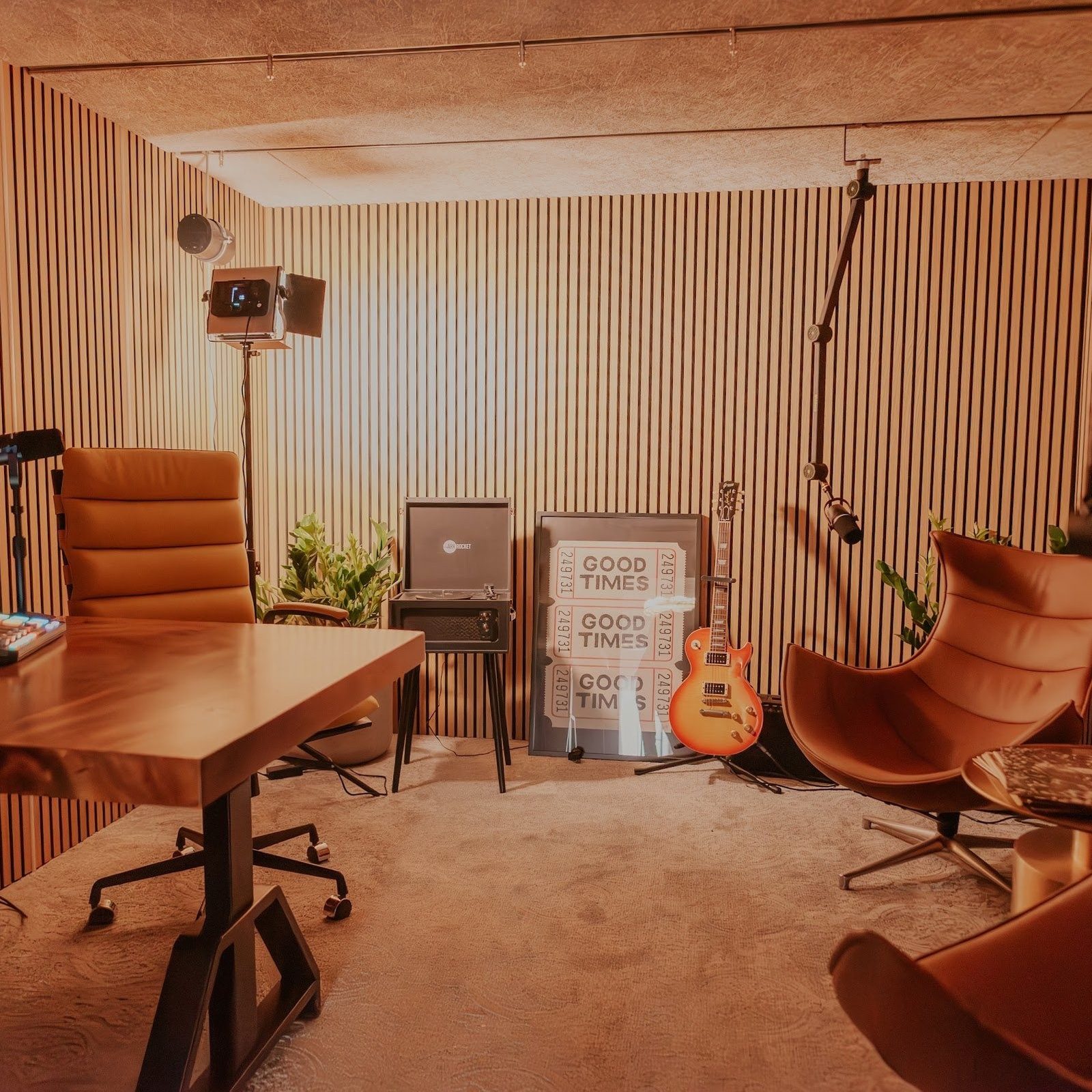 Wide view of The Vault studio showing the recording table, seating and the slatted acoustic walls