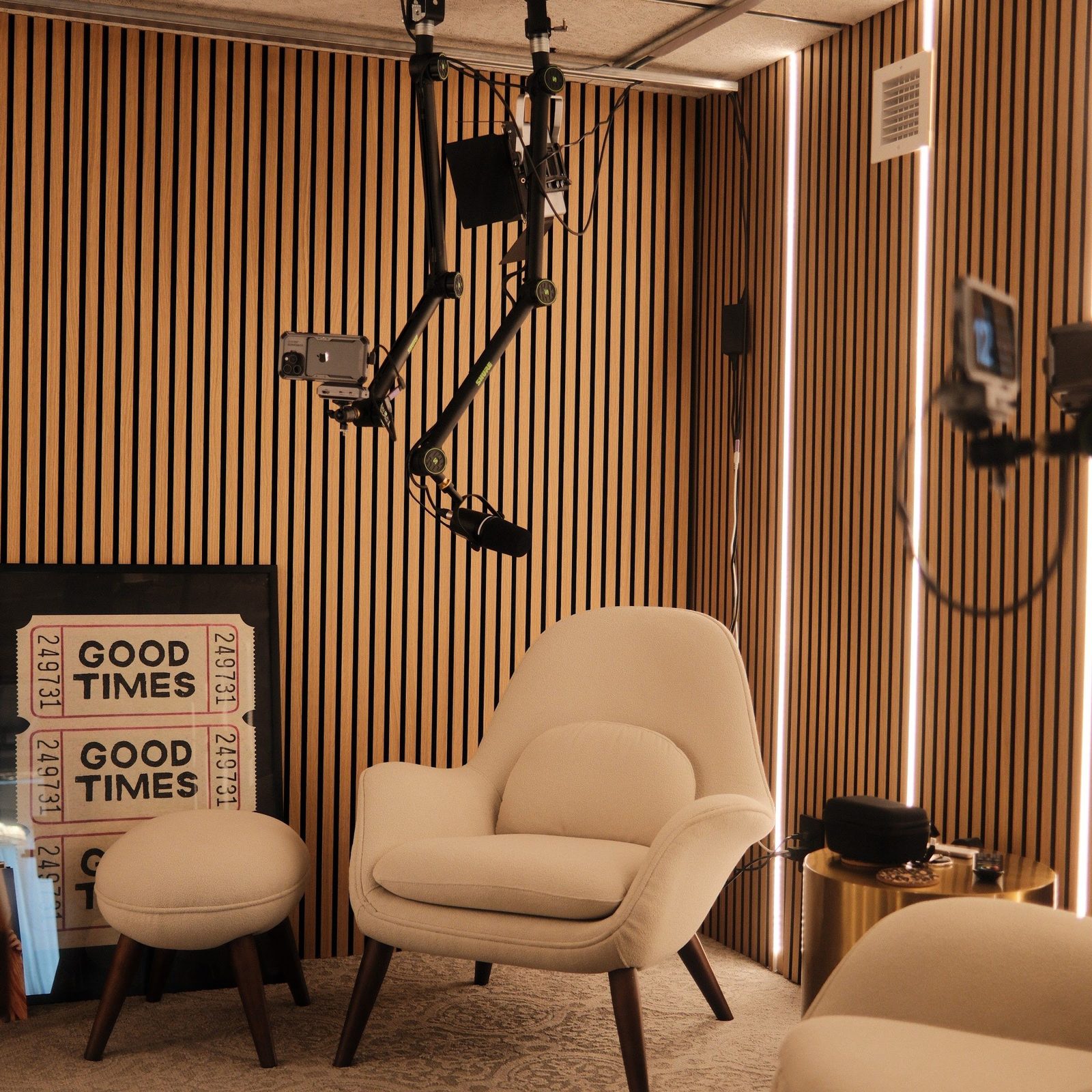 The armchair corner of the studio set up with a boom microphone for a seated interview