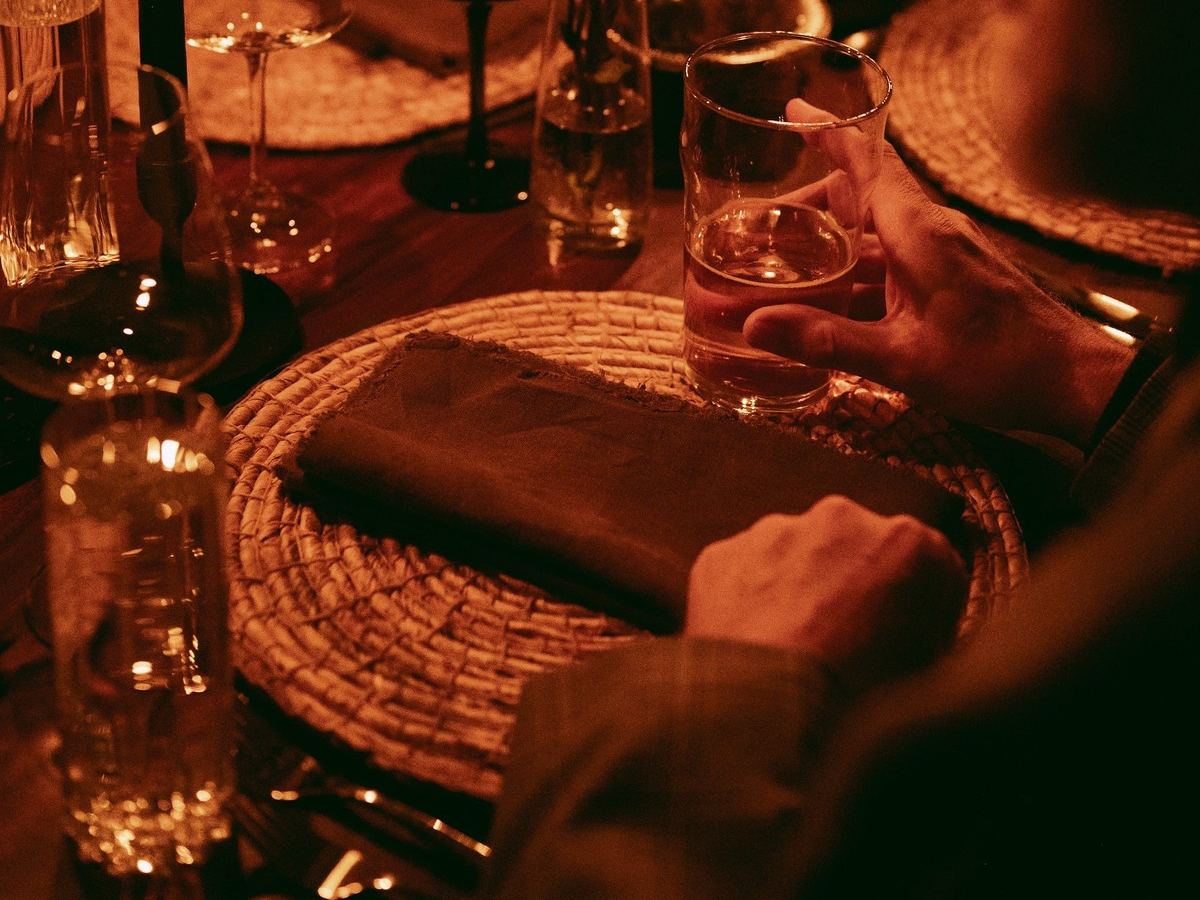 An intimate candlelit dinner table set at Den 1880