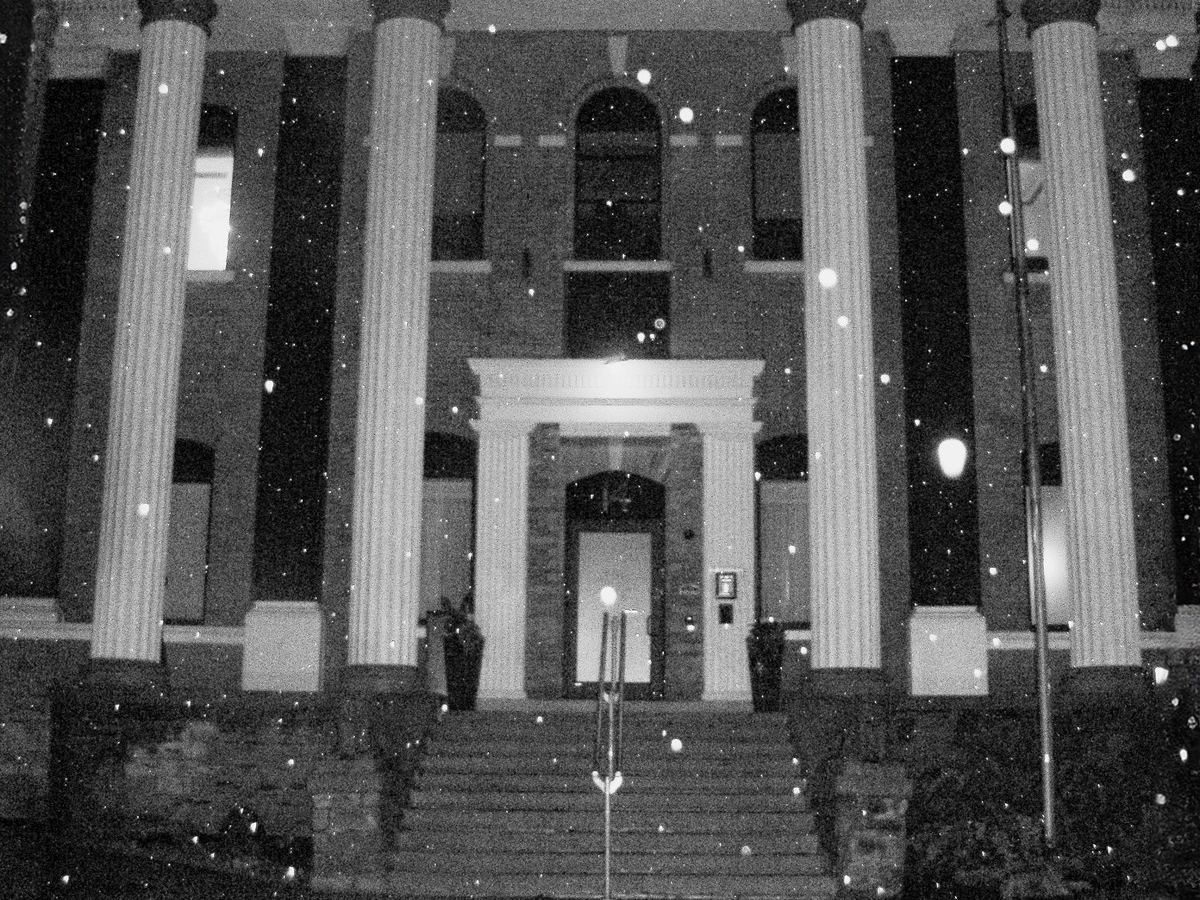 The heritage facade of Den 1880 at night